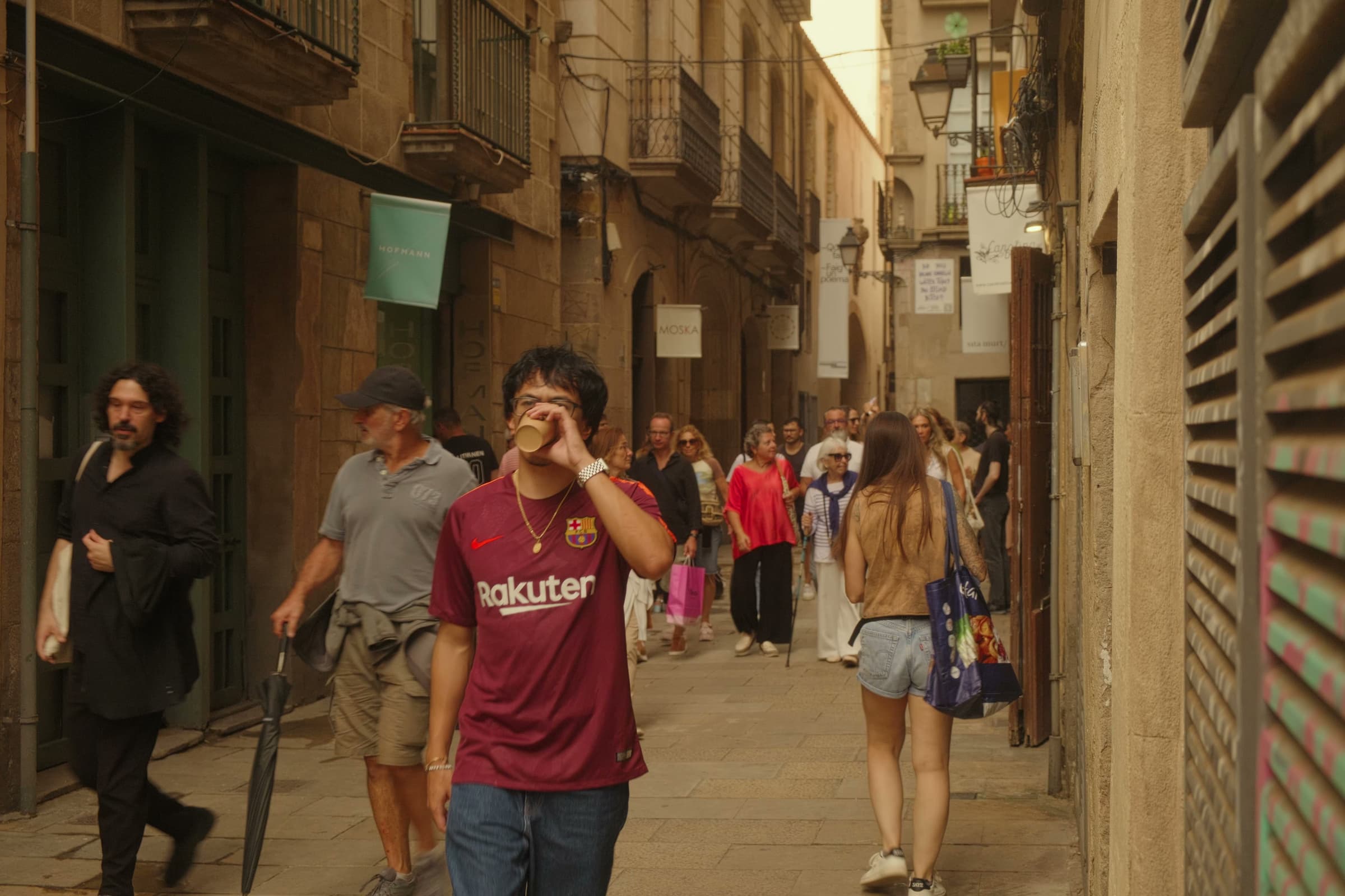 Andrew Amisola in Europe in a Minute — Andrew wearing a Barcelona FC jersey in a narrow Gothic Quarter alley.