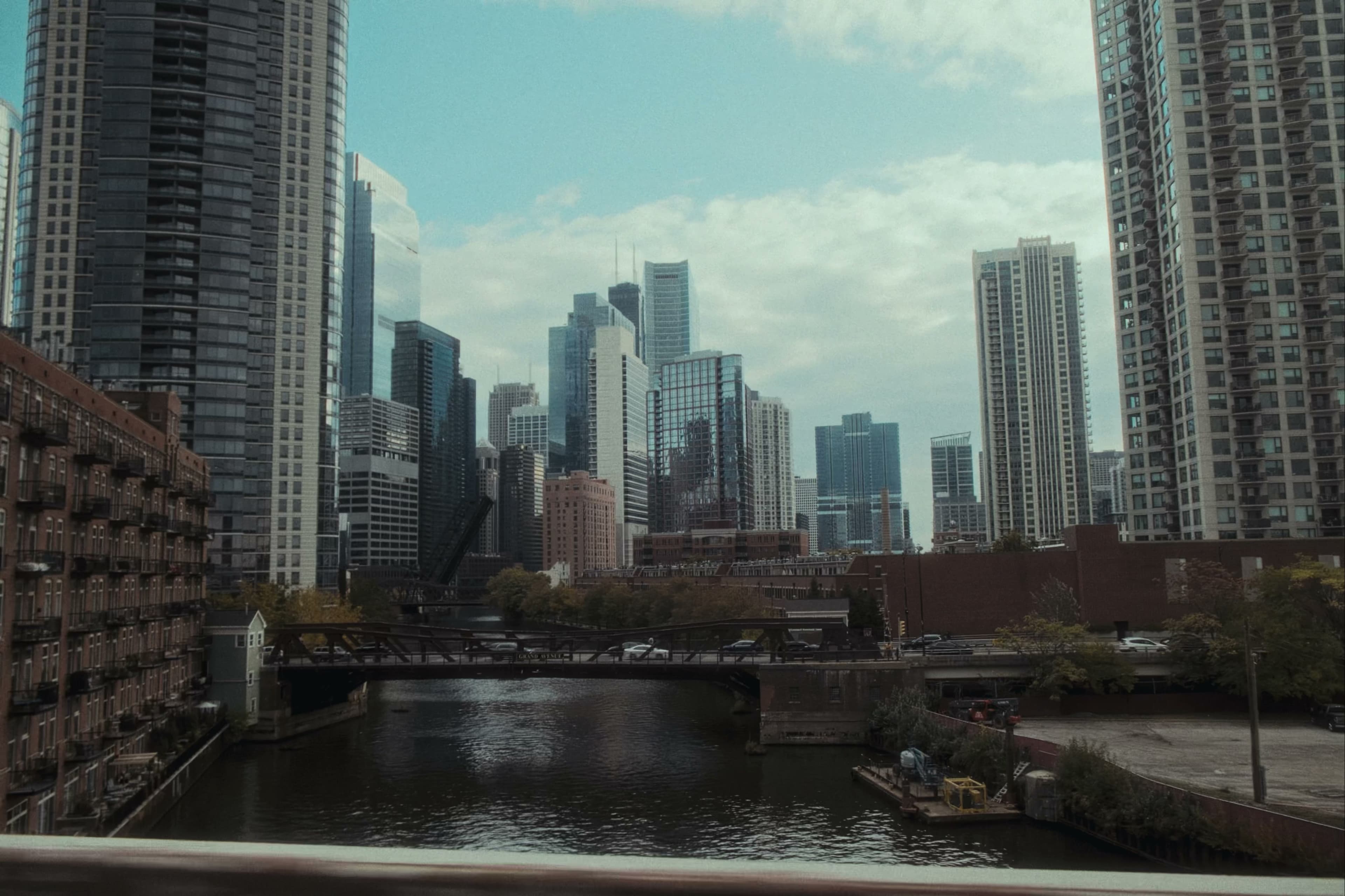 Chicago River with drawbridge and downtown skyline.