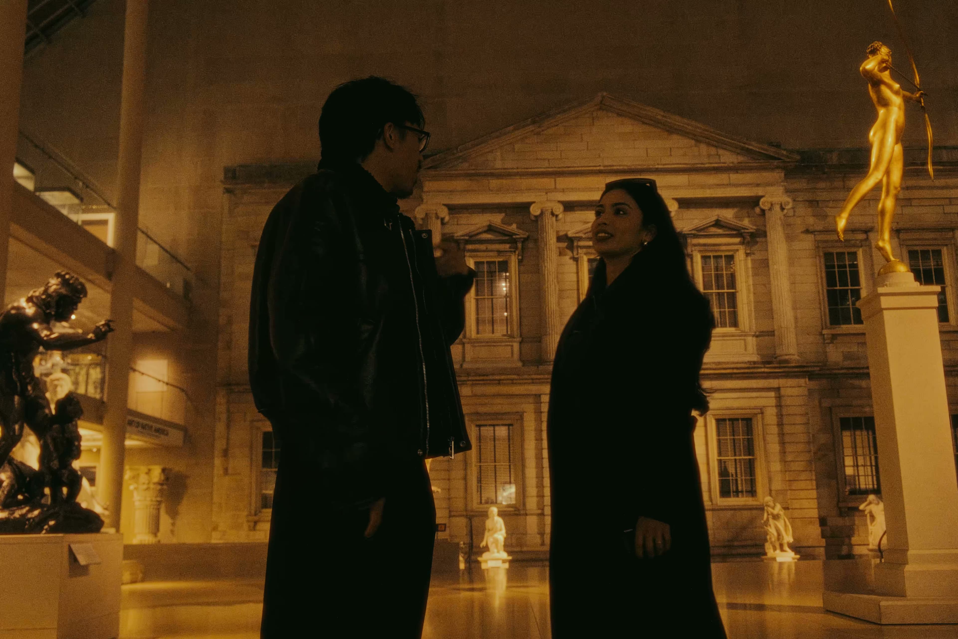 Andrew and a friend talking in the American Wing sculpture court with Diana statue behind them.