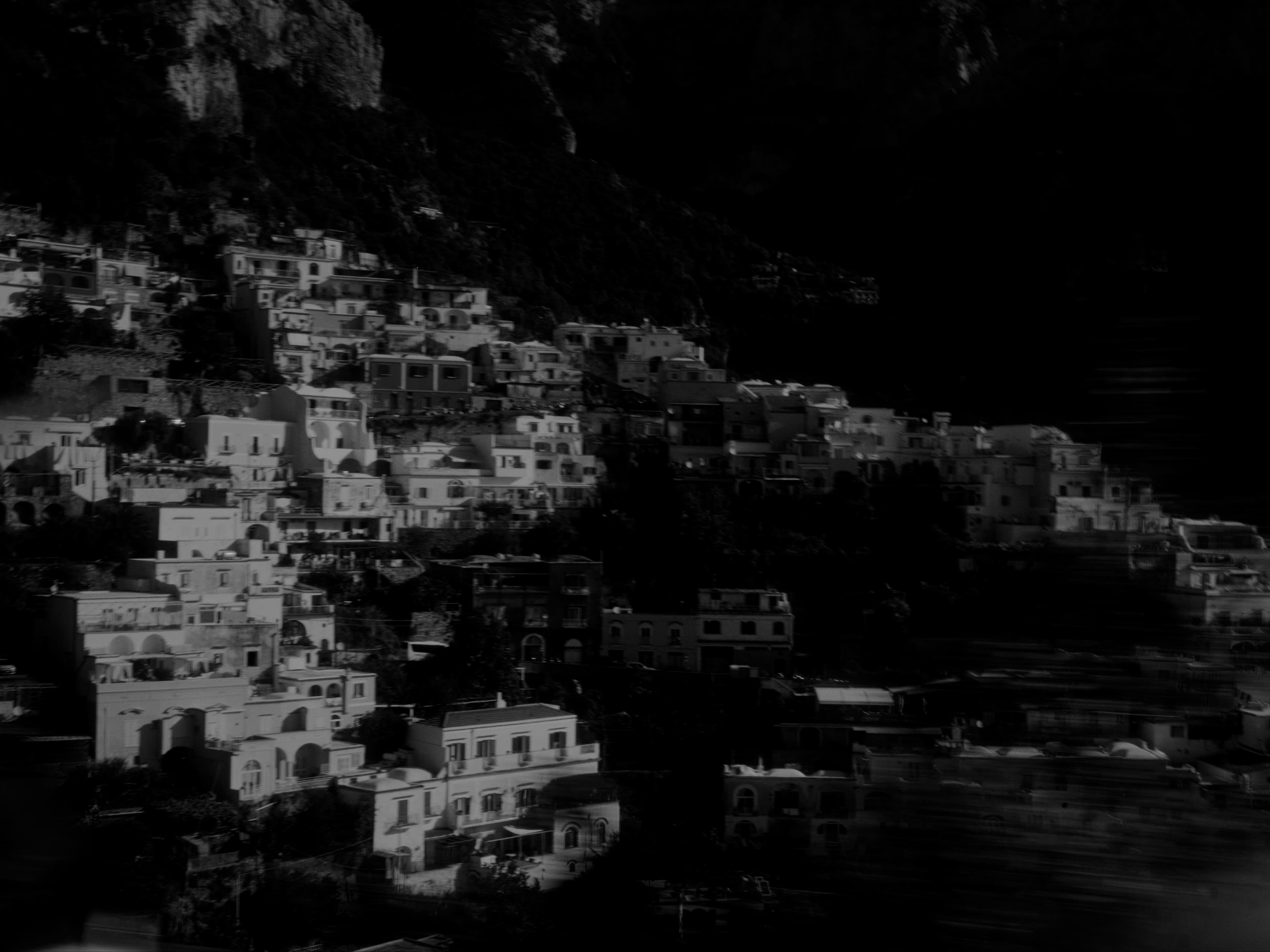 Positano's stacked buildings in black and white