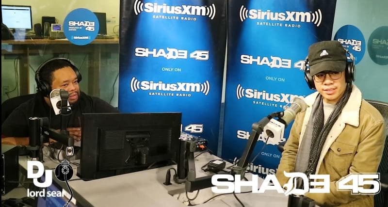 Andrew Amisola on the right, in headphones at a studio microphone across from host DJ Lord Sear, in the Shade 45 studio at SiriusXM